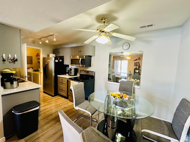 4110 S Oak Meadows Dr Unit 20, Taylorsville, UT 84123 - dining room with light wood-type flooring, visible vents, ceiling fan, and baseboards