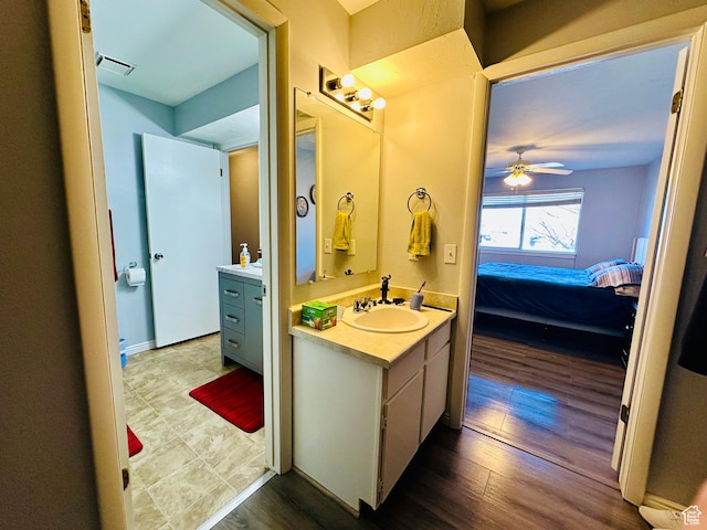 4110 S Oak Meadows Dr Unit 20, Taylorsville, UT 84123 - bathroom featuring visible vents, connected bathroom, vanity, and wood finished floors