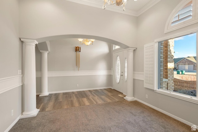 interior space with arched walkways, carpet floors, a notable chandelier, and a high ceiling
