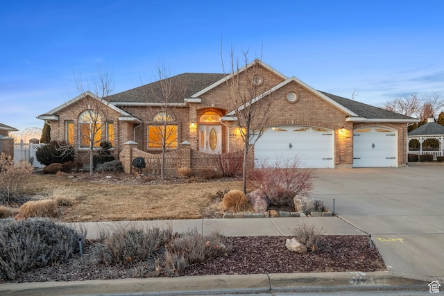 single story home featuring a garage, brick siding, a shingled roof, and concrete driveway