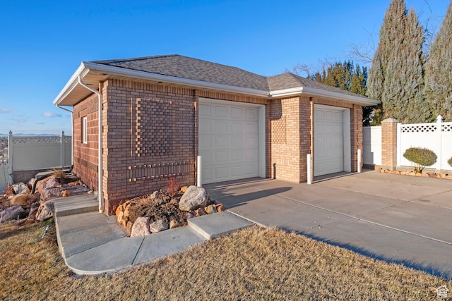 exterior space featuring fence and concrete driveway