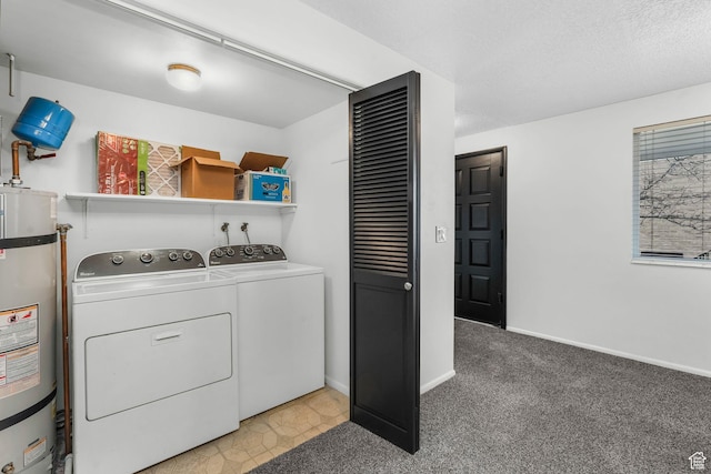 clothes washing area featuring light carpet, laundry area, baseboards, washer and clothes dryer, and strapped water heater