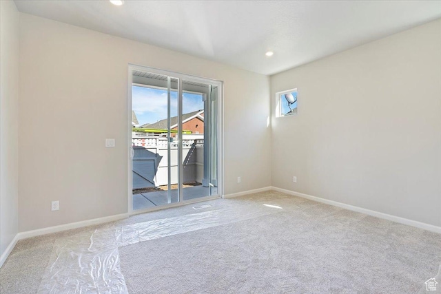 empty room with light carpet, plenty of natural light, and recessed lighting