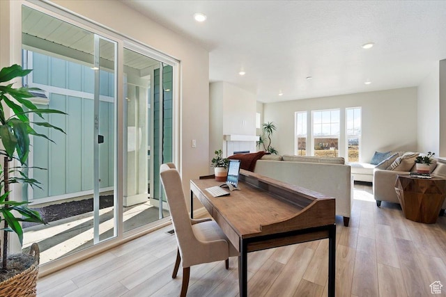 dining space with light wood-style floors and recessed lighting