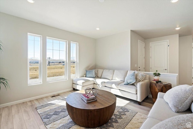 living room with visible vents, recessed lighting, light wood-style flooring, and baseboards