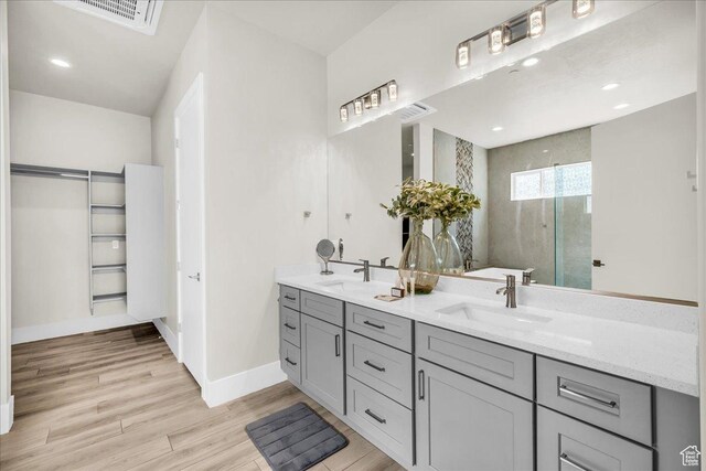 5159 W 2200 S, Hurricane, UT 84737 - bathroom with double vanity, baseboards, a sink, and wood finished floors