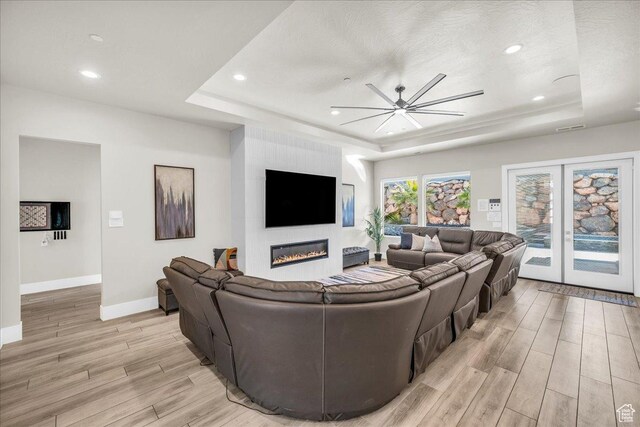5159 W 2200 S, Hurricane, UT 84737 - living area with a large fireplace, a ceiling fan, baseboards, light wood-style floors, and a raised ceiling