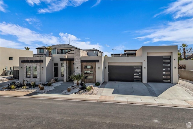 5159 W 2200 S, Hurricane, UT 84737 - modern home featuring an attached garage, concrete driveway, and stucco siding