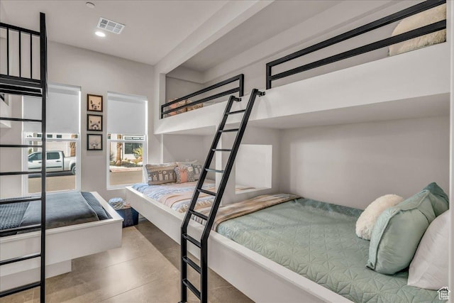 bedroom with concrete flooring, visible vents, and recessed lighting