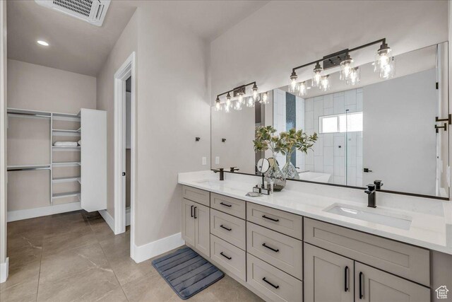 full bathroom with visible vents, a sink, baseboards, and double vanity
