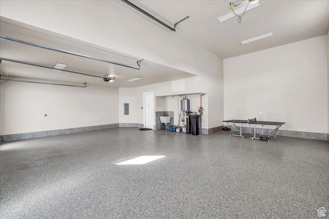 garage with electric panel, baseboards, and a garage door opener