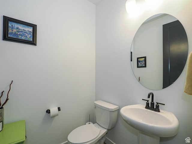 half bath featuring a sink and toilet