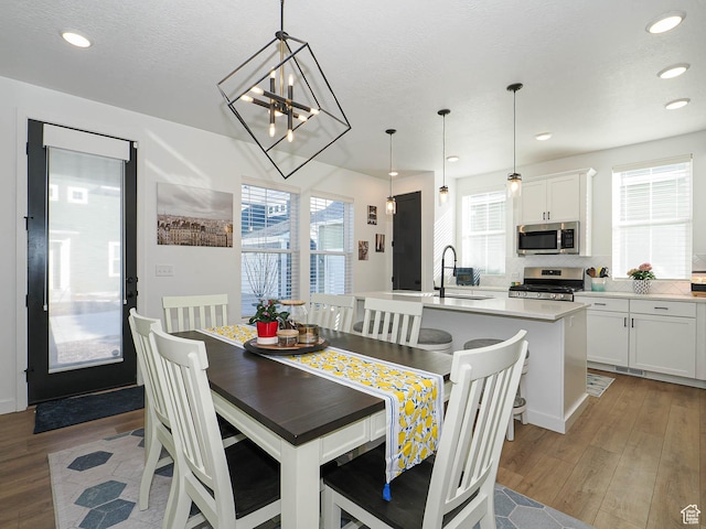 dining room with recessed lighting, light wood-style flooring, and a healthy amount of sunlight