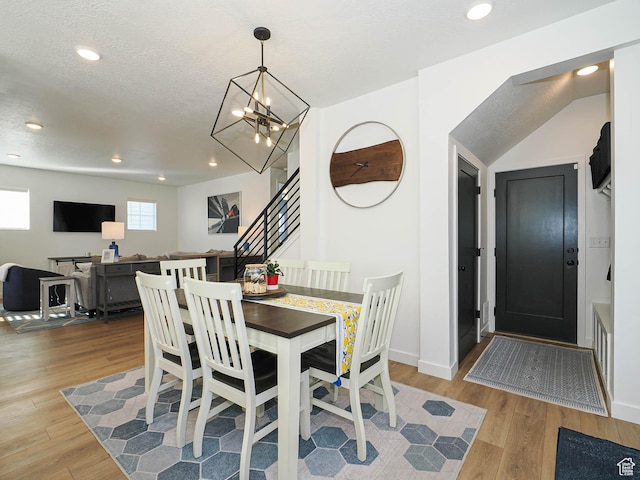 dining space featuring stairs, a textured ceiling, wood finished floors, and recessed lighting