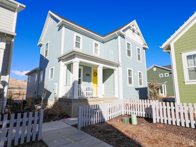view of front facade with fence and a porch