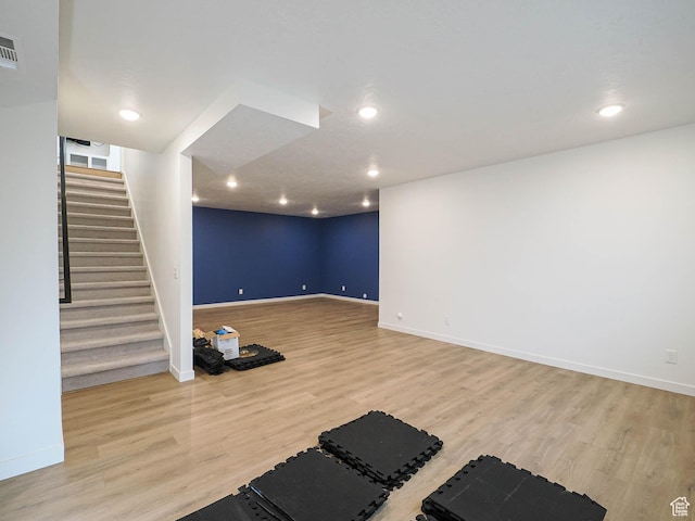 workout area with recessed lighting, wood finished floors, visible vents, and baseboards