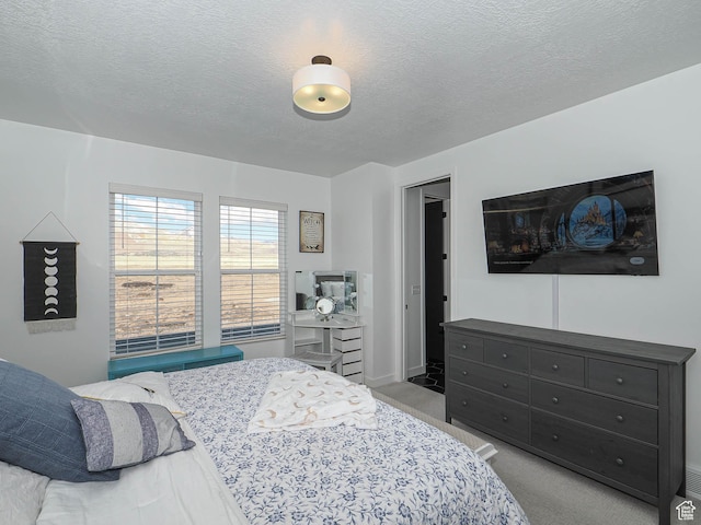 carpeted bedroom featuring a textured ceiling