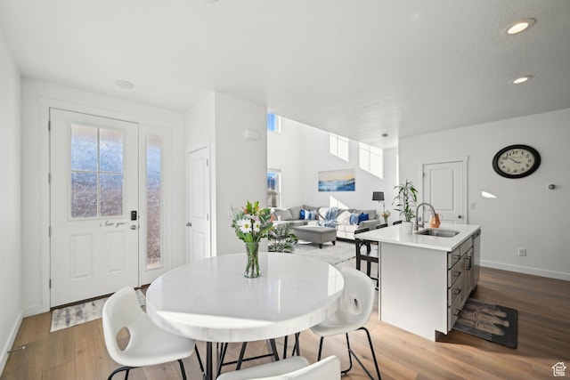 dining area with recessed lighting, wood finished floors, and baseboards