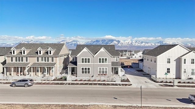 view of front of house featuring board and batten siding, a residential view, and a mountain view