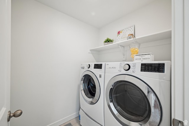 laundry room featuring laundry area, washer and clothes dryer, and baseboards