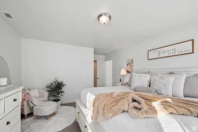 carpeted bedroom with visible vents