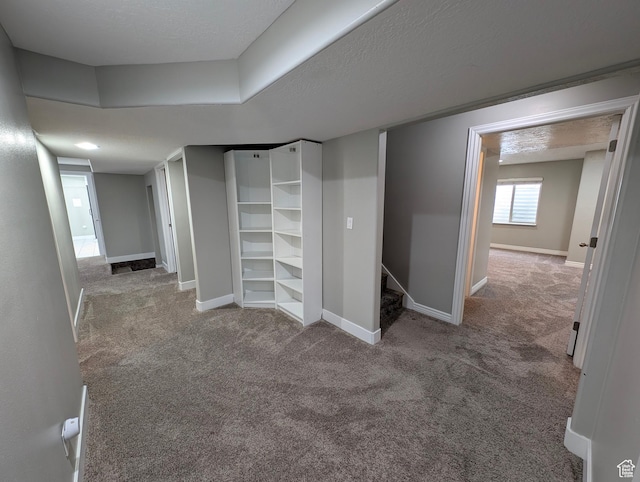 basement featuring carpet flooring and baseboards