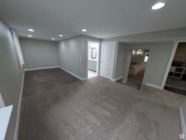 finished below grade area featuring carpet flooring, recessed lighting, baseboards, and wood finished floors