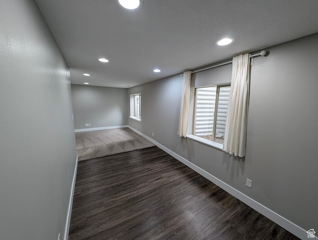 basement with wood finished floors, recessed lighting, and baseboards