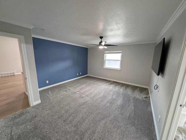 unfurnished bedroom with carpet flooring, baseboards, crown molding, ceiling fan, and a textured ceiling