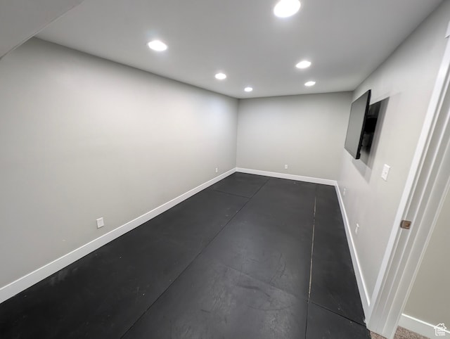 below grade area with baseboards and recessed lighting