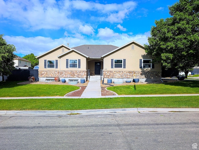 view of front of property with stone siding, stucco siding, and a front yard