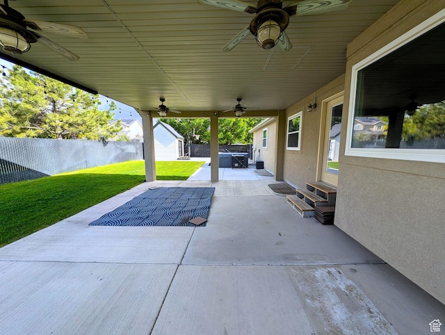 view of patio with ceiling fan, entry steps, an outdoor structure, and a storage unit