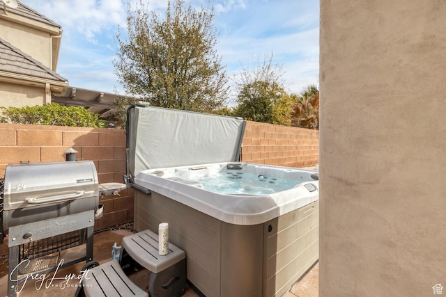 395 W Granite Dr, Washington, UT 84780 - view of patio / terrace with a hot tub, fence, and a grill