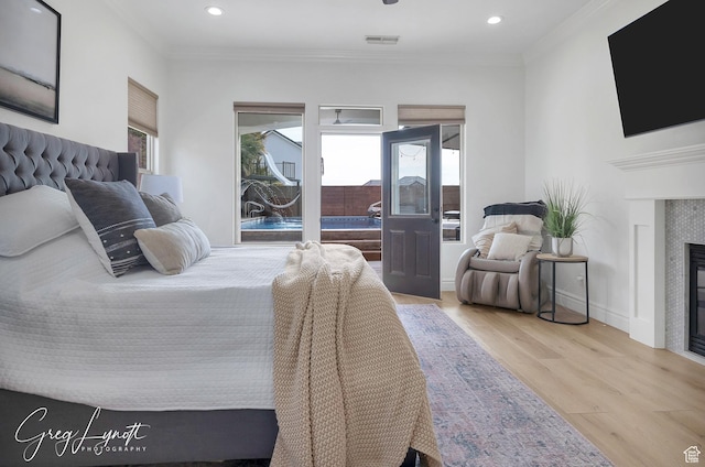 395 W Granite Dr, Washington, UT 84780 - bedroom with a glass covered fireplace, wood finished floors, crown molding, recessed lighting, and baseboards
