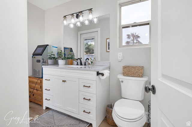 395 W Granite Dr, Washington, UT 84780 - bathroom with toilet, vanity, and wood finished floors