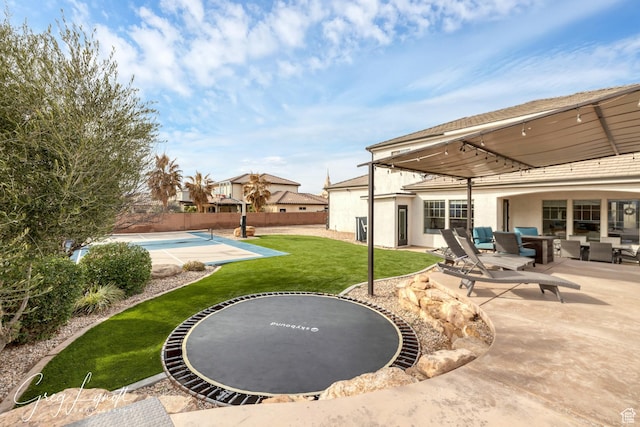 395 W Granite Dr, Washington, UT 84780 - view of yard featuring a trampoline, a patio, and an outdoor hangout area