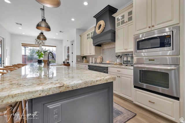 395 W Granite Dr, Washington, UT 84780 - kitchen with stainless steel appliances, a sink, light stone countertops, light wood finished floors, and recessed lighting