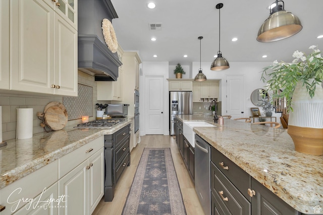 395 W Granite Dr, Washington, UT 84780 - kitchen with a sink, stainless steel appliances, backsplash, custom exhaust hood, and light stone counters