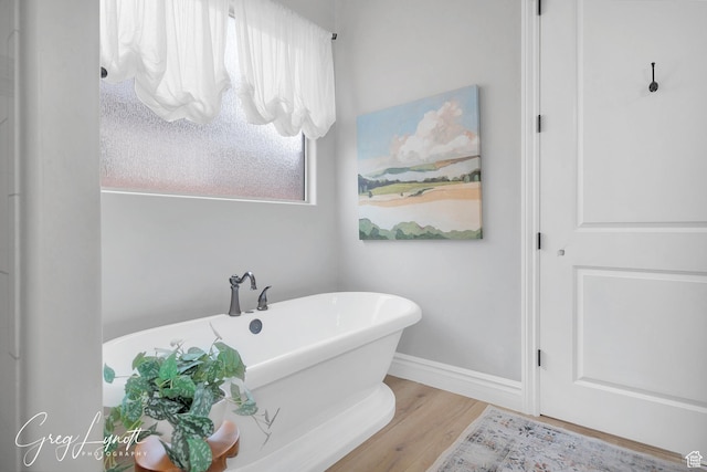 395 W Granite Dr, Washington, UT 84780 - bathroom with a soaking tub, wood finished floors, and baseboards