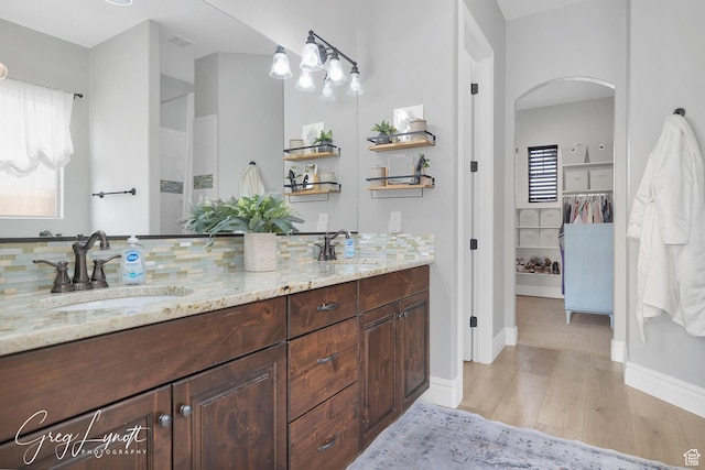 395 W Granite Dr, Washington, UT 84780 - full bath with wood finished floors, tasteful backsplash, double vanity, and baseboards