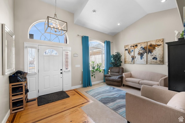 entrance foyer featuring a notable chandelier, recessed lighting, wood finished floors, high vaulted ceiling, and baseboards