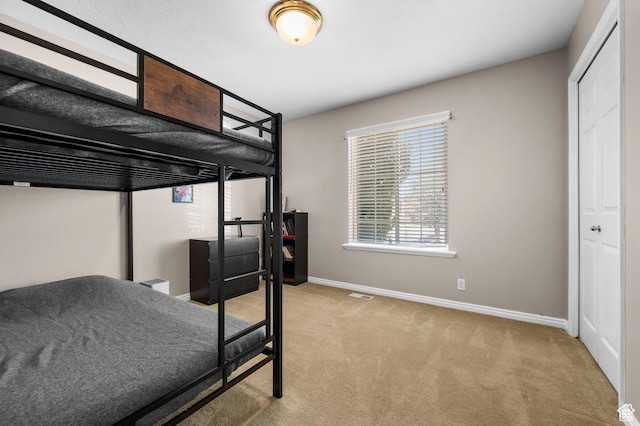 bedroom featuring carpet, visible vents, and baseboards