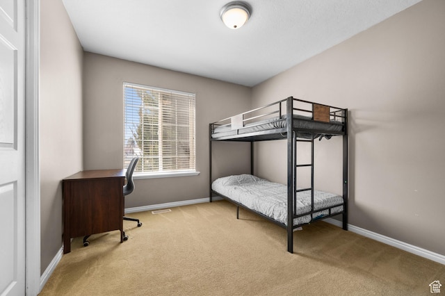 bedroom featuring carpet floors and baseboards