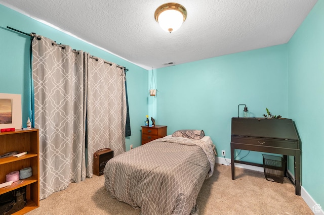 carpeted bedroom with a textured ceiling, visible vents, and baseboards