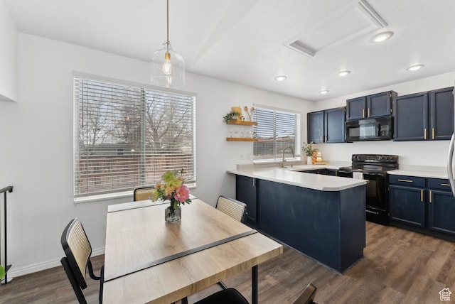 kitchen with dark wood-style floors, blue cabinetry, light countertops, a peninsula, and black appliances