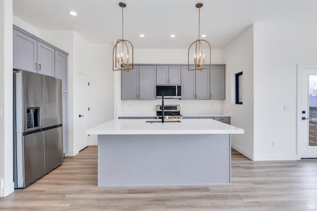 5328 W Dosh Ln Unit 40, Highland, UT 84003 - kitchen featuring gray cabinetry, a sink, light countertops, appliances with stainless steel finishes, and light wood finished floors