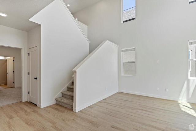 818 W 1100 N Unit 140, North Salt Lake, UT 84054 - stairs with wood finished floors, plenty of natural light, a high ceiling, and recessed lighting