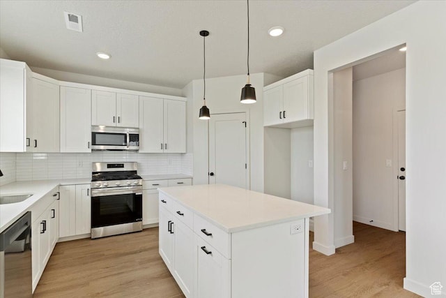 818 W 1100 N Unit 140, North Salt Lake, UT 84054 - kitchen with appliances with stainless steel finishes, backsplash, light wood-style flooring, recessed lighting, and white cabinets