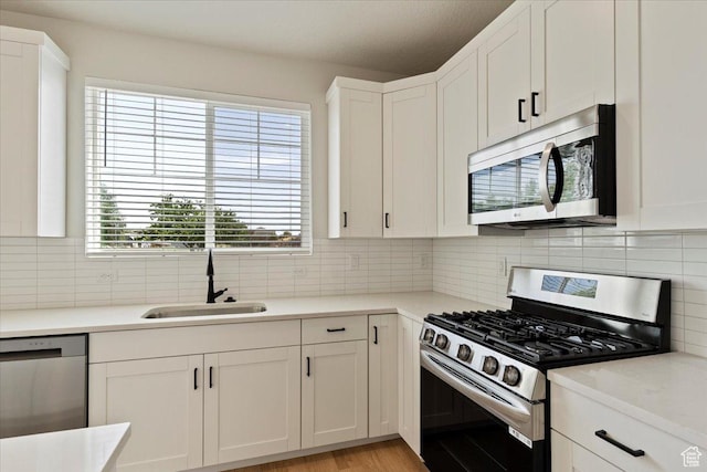 818 W 1100 N Unit 140, North Salt Lake, UT 84054 - kitchen with stainless steel appliances, white cabinetry, decorative backsplash, and light countertops