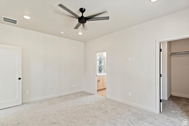 818 W 1100 N Unit 140, North Salt Lake, UT 84054 - unfurnished bedroom with a spacious closet, light colored carpet, recessed lighting, ensuite bathroom, and a closet